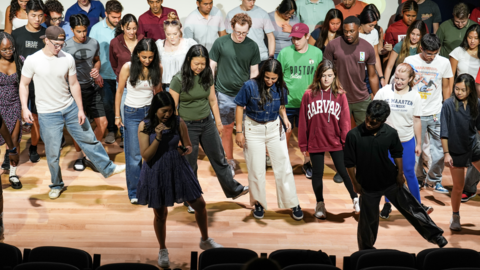 Students learning to dance on the stage at the LIFE talent show