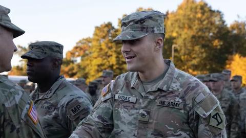 National Guardsman Joseph Fadule ’26 shakes hands after receiving an award for having one of the top 5 fitness test scores in his brigade.