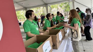 Volunteers help students get set up to go on their community projects as part of the Harvard College Global Day of Service in the Science Center Plaza Tent.