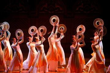 An Asian dance group performs a traditional dance in traditional garb during Cultural Rhythms.