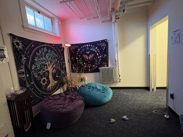 The Cabot House meditation space with two beanbags and two blanket murals on the wall.