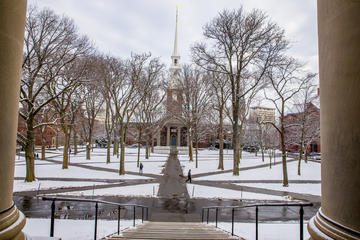 A view of memorial church in the wintertime covered in snow.