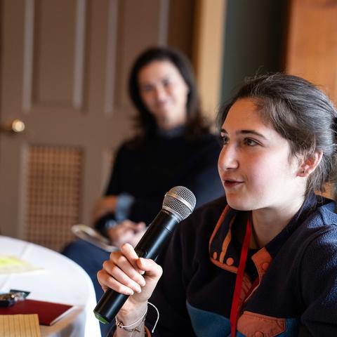Ari Kohn shares her thoughts on mattering with the room on the mic during the retreat.