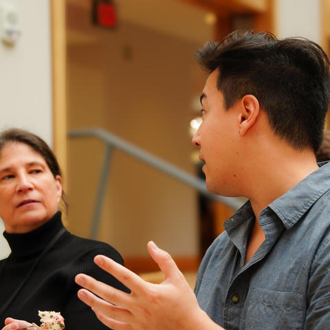 A student shares his take on what can improve student survey engagement at a meeting.
