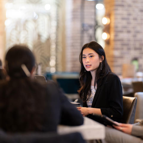 Students gathered at a table in discussion at the 2025 United Nations Convening on the Concerns of Women.