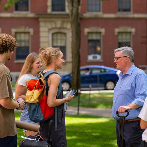 Dean Thomas Dunne helping first-year students move in and meeting families.