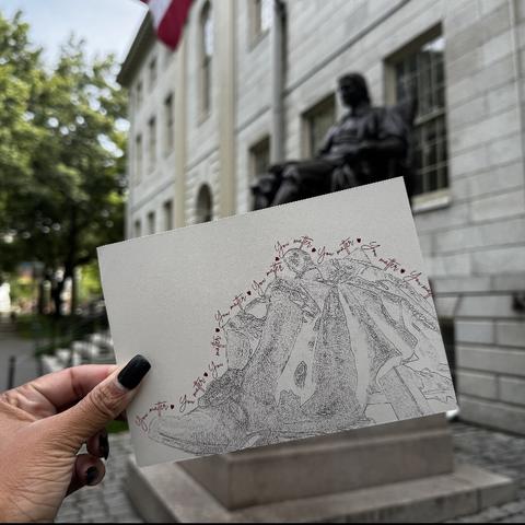John Harvard Statue, Hand holding postcard of statue.