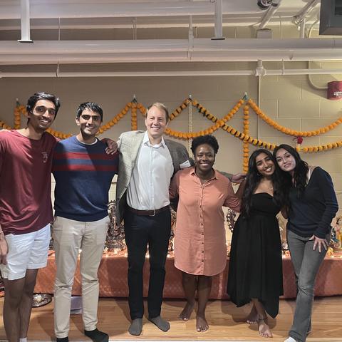 Dean Alta Mauro and Danoff Dean David Deming pose for a photo with four students at the opening event of their new religious prayer space.