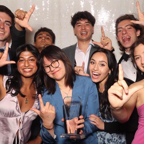 Students from Lowell House pose in the photo booth at the Johnnies after receiving their award.