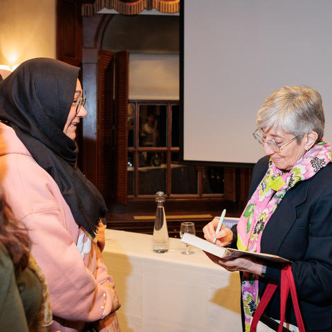 Dr. Sima Simar signs her book for student attendees following her Peggy Schmertzler leadership seminar.