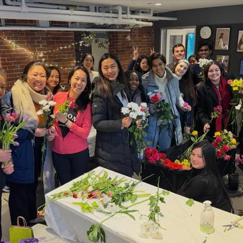 Students pose with their fresh bouquets in the grays basement for the Women's Week bouquet giveaway.