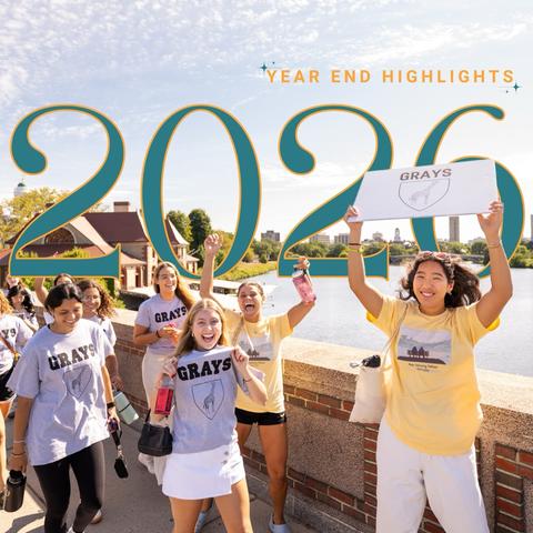 Front cover art of the year-end highlights report with first-year students and PAFs crossing the Anderson bridge to the Harvard Allston campus.
