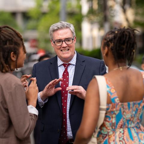 Dean of Students, Tom Dunne, talks with two students outside of his residence at 53 Dunster Street.