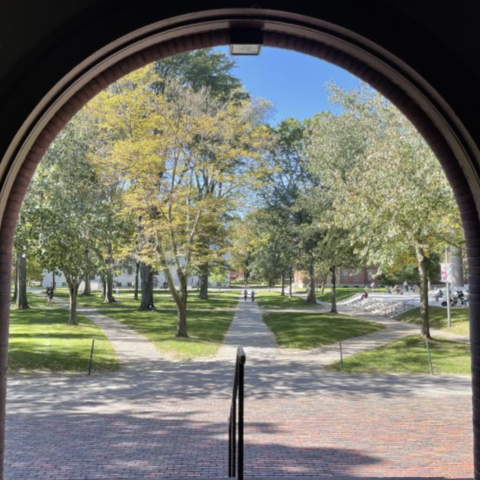 Tecentenary theatre framed by the round arches of an open Sever Hall.