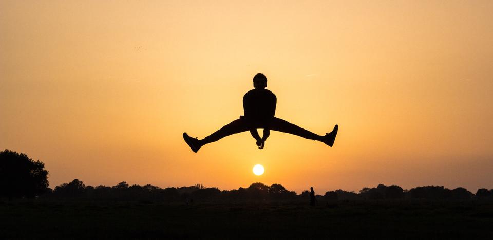 Person jumping with sunset by Marc Najera on Unsplash