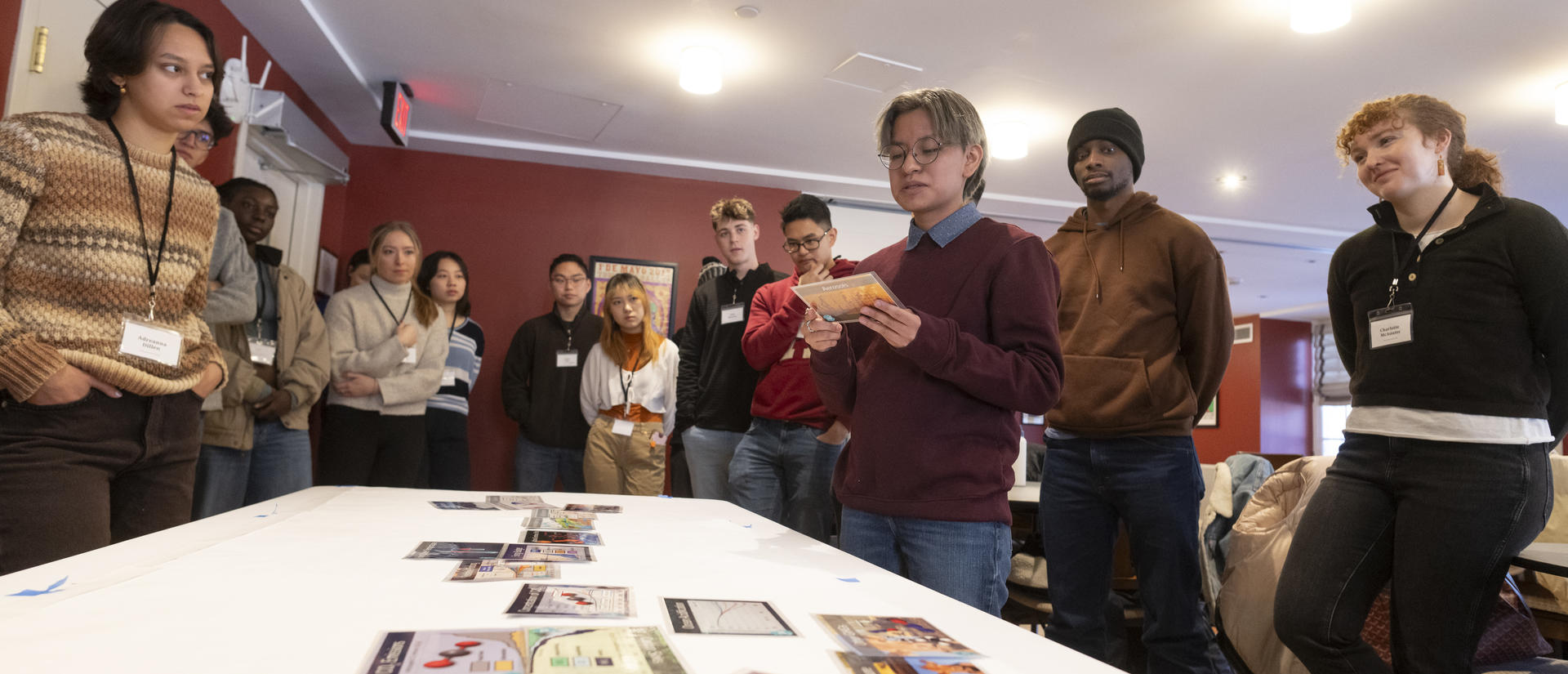 Students gathered around a table reviewing information at a climate action camp.