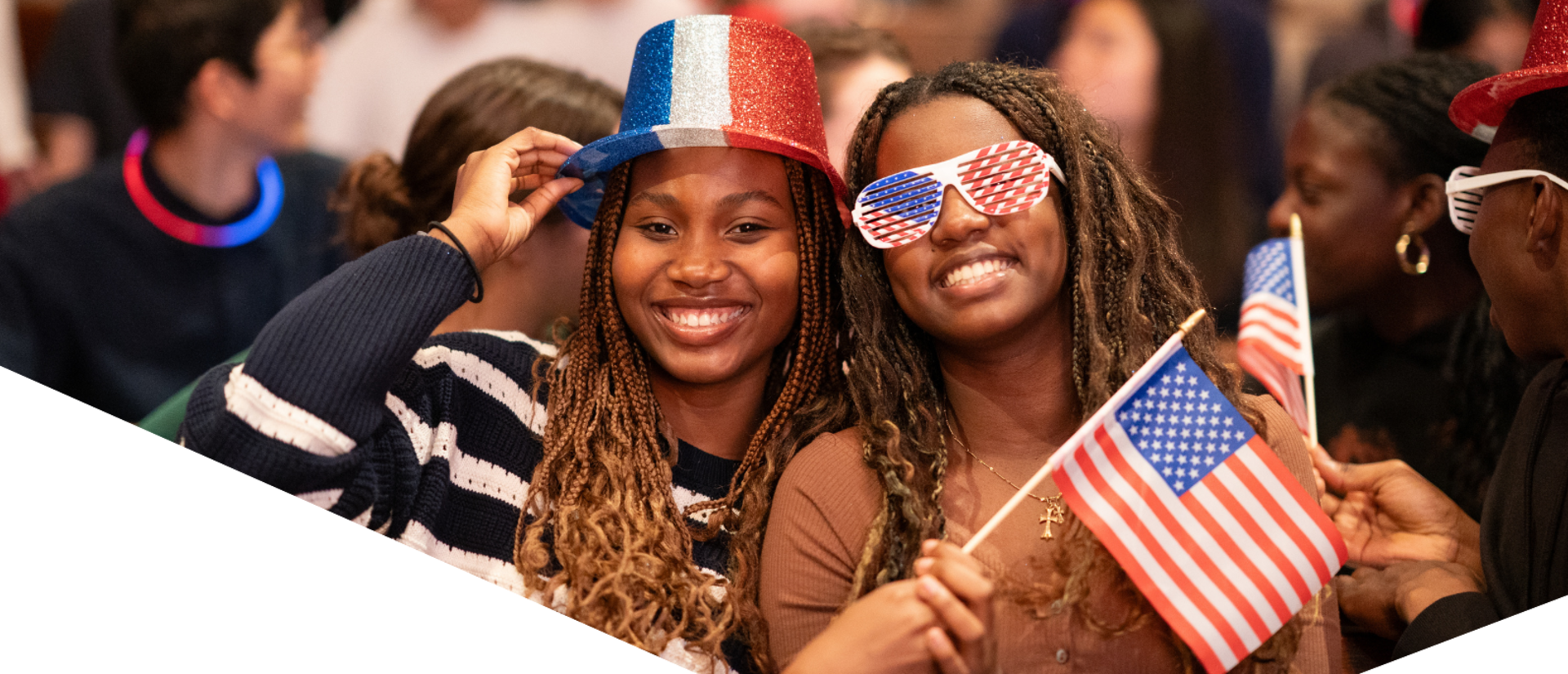 Two students pose for a photo in the bleachers of Sanders Theater during the live 2024 presidential election watch party.