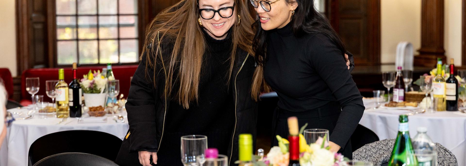 Two staff members share a hug at a DSO-sponsored passover seder.