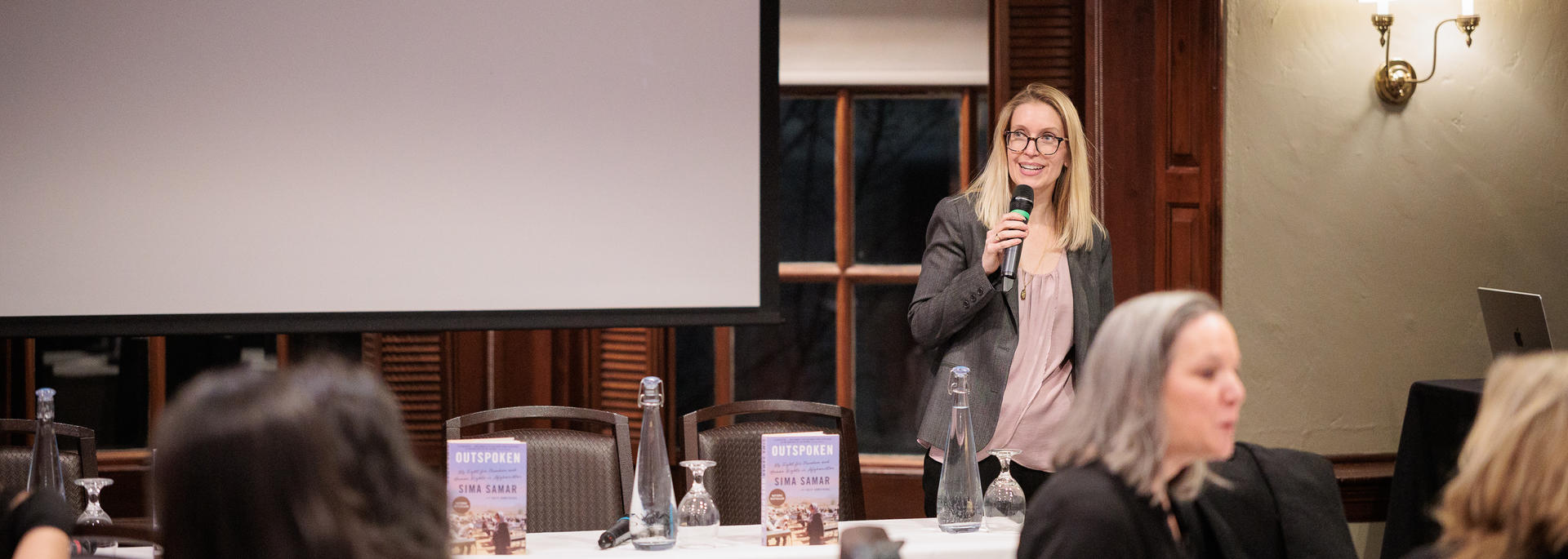 Director Bonnie Talbert addressing the room of attendees during the 2026 Women's Week Schmertzler lecture.