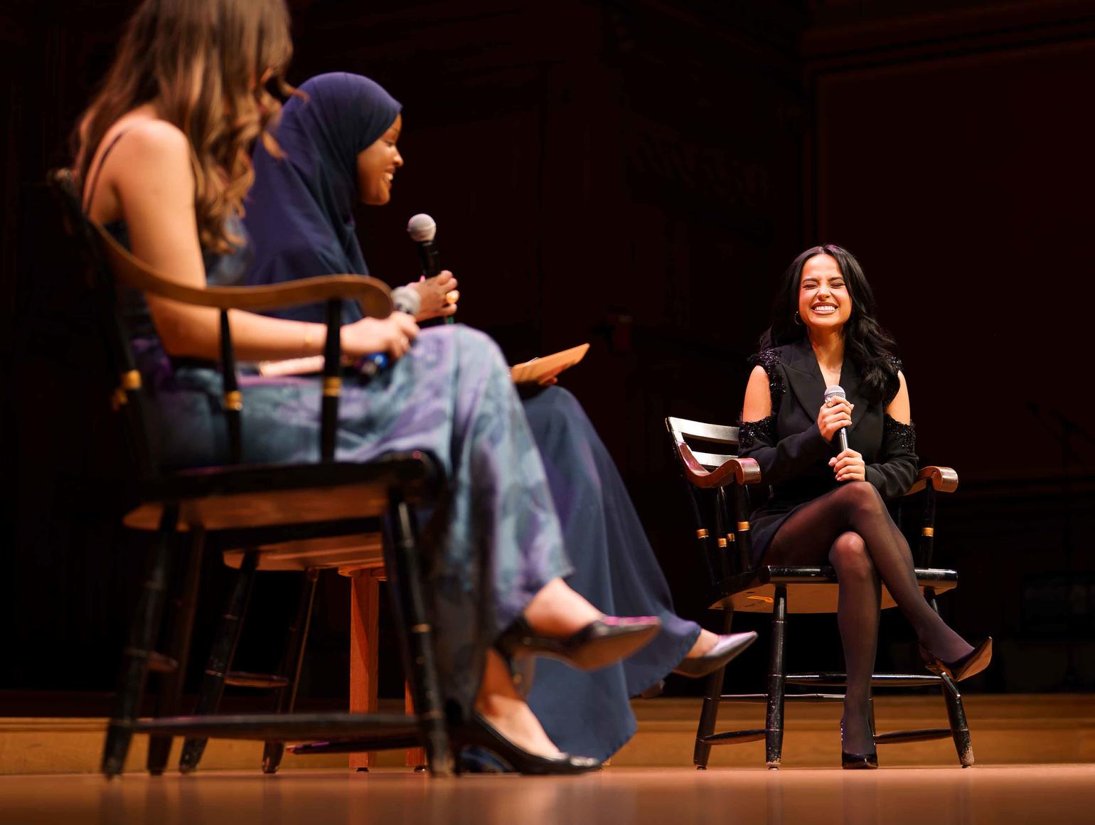 Becky G on stage with two student organizers of the 2025 Cultural Rhythms program.