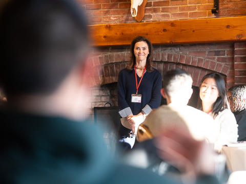 A facilitator looks out at the attendees of the mattering retreat as a group discussion ensues.