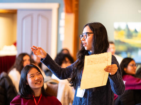 A student at the mattering retreat shares her table's notes.