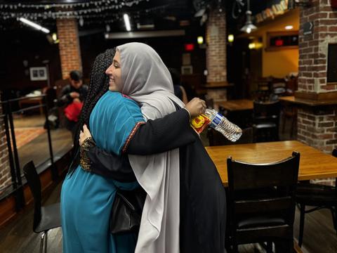 Dean Alta Mauro shares an embrace with a student during the DSO-sponsored iftar during Ramadan 2025.