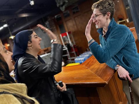 DSO staff member high-fives a student during the DSO-sponsored iftar during Ramadan 2025.