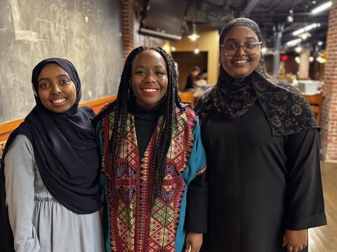 Dean Alta Mauro poses for a photo with two students during the DSO-sponsored iftar during Ramadan 2025.