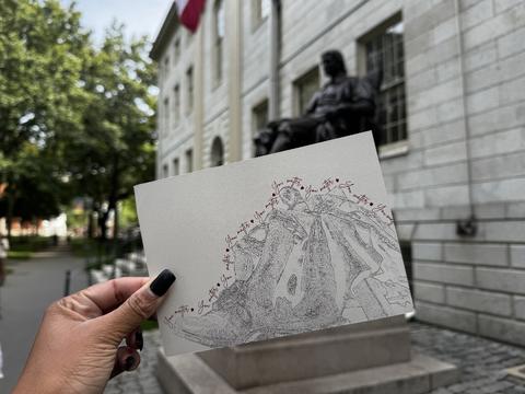 John Harvard Statue, Hand holding postcard of statue.
