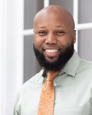 A headshot of Brandon Tilghman.