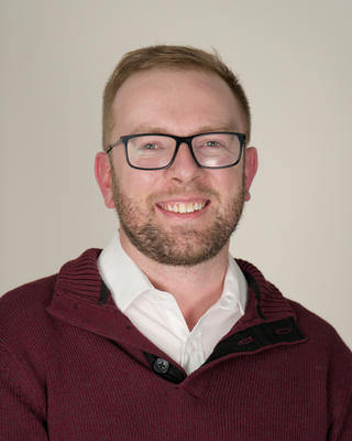 A headshot of Brett Monson.