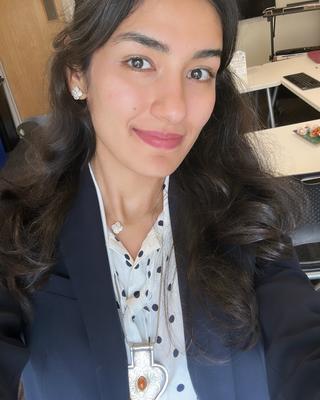 Headshot of Jennet in suit