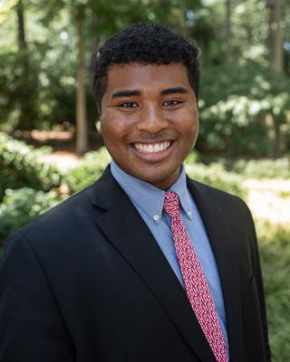 A headshot of James Obasiolu.