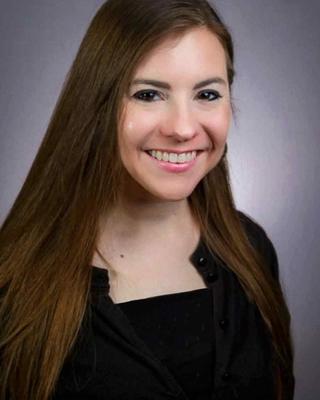 A headshot of Emilie Raymer.