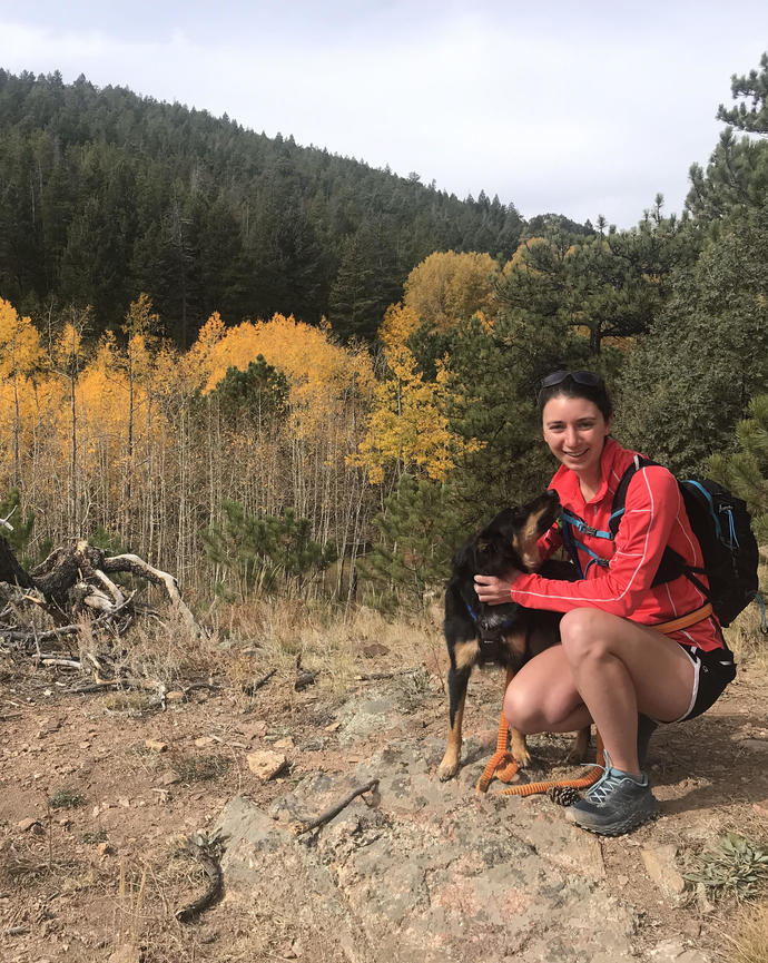 Pic of Jenn and her dog on a mountain