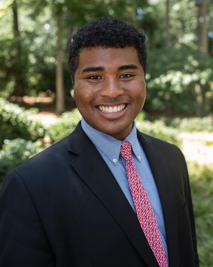 A headshot of James Obasiolu.